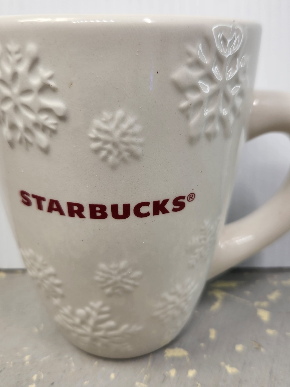 Starbucks White Snowflake Embossed Mug with Red Logo